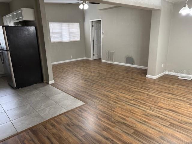 160 S Oxalis Dr, Orlando, FL 32807 - interior space with light wood finished floors, visible vents, ceiling fan with notable chandelier, and baseboards