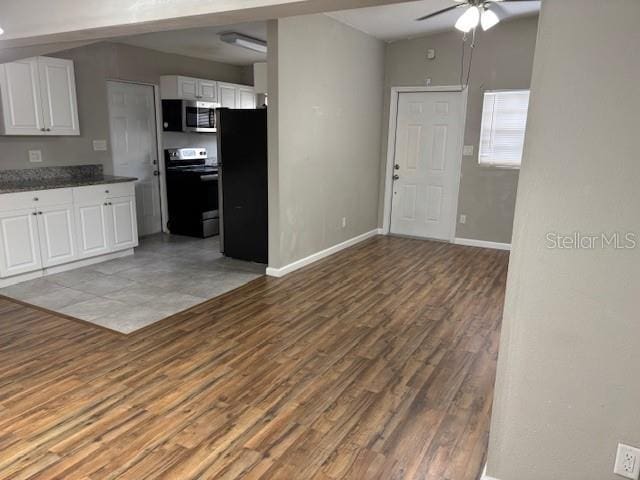 160 S Oxalis Dr, Orlando, FL 32807 - kitchen with white cabinetry, a ceiling fan, dark countertops, stainless steel appliances, and wood finished floors