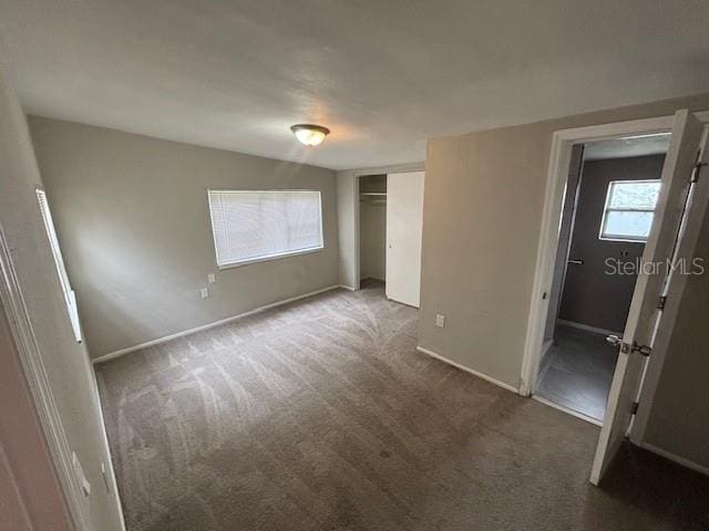 160 S Oxalis Dr, Orlando, FL 32807 - unfurnished bedroom featuring a closet, baseboards, and carpet