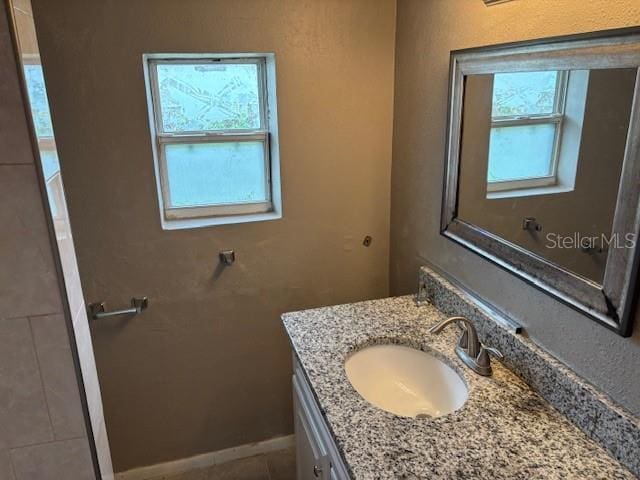 160 S Oxalis Dr, Orlando, FL 32807 - bathroom featuring vanity, baseboards, and plenty of natural light