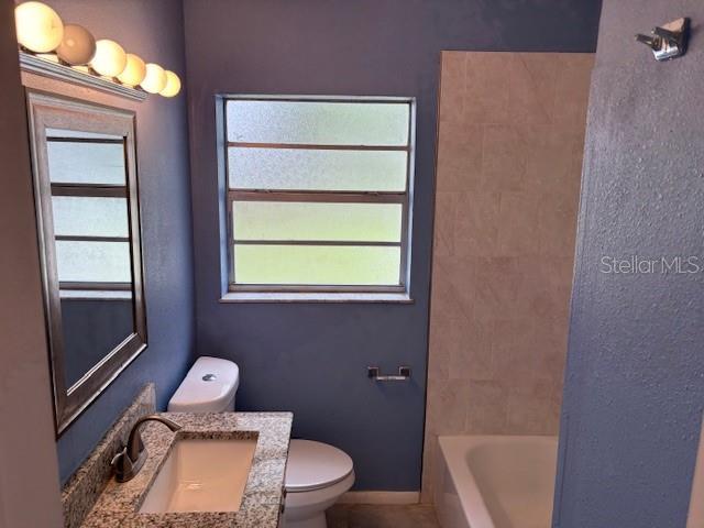 160 S Oxalis Dr, Orlando, FL 32807 - bathroom featuring plenty of natural light, vanity, baseboards, and toilet
