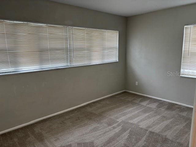 160 S Oxalis Dr, Orlando, FL 32807 - carpeted spare room with baseboards and plenty of natural light