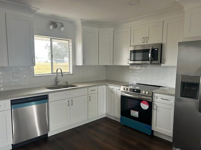 702 Desert Hills Way, Sun City Center, FL 33573 - kitchen featuring tasteful backsplash, white cabinets, a sink, appliances with stainless steel finishes, and dark wood-style floors