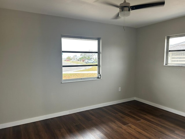 702 Desert Hills Way, Sun City Center, FL 33573 - unfurnished room with dark wood-type flooring, baseboards, and ceiling fan