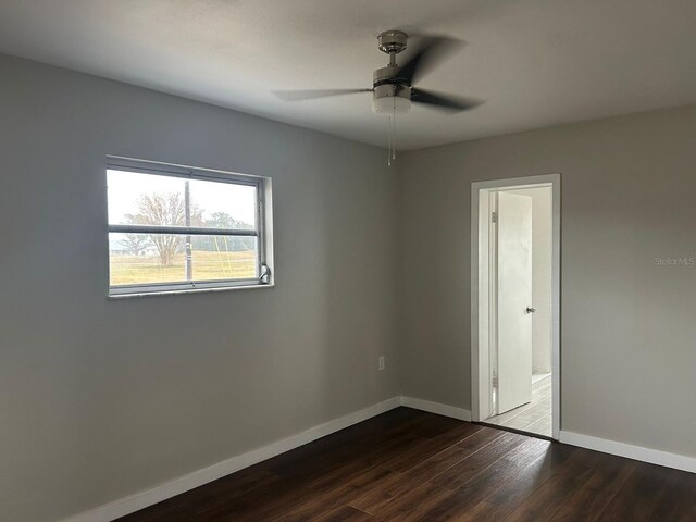 702 Desert Hills Way, Sun City Center, FL 33573 - spare room featuring baseboards, a ceiling fan, and wood finished floors