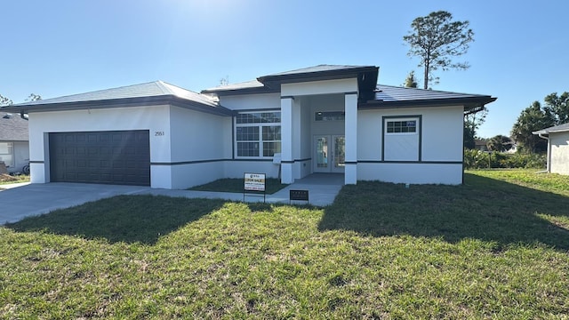 2551 Alhaven Ter, North Port, FL 34286 - prairie-style home featuring a garage, concrete driveway, french doors, a front yard, and stucco siding