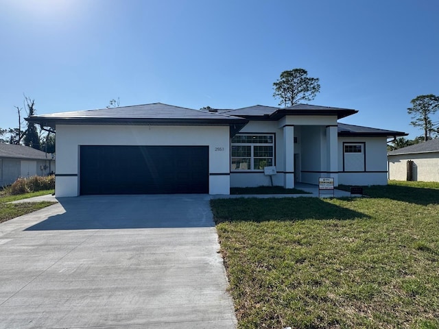 2551 Alhaven Ter, North Port, FL 34286 - prairie-style house featuring stucco siding, concrete driveway, a front yard, and an attached garage