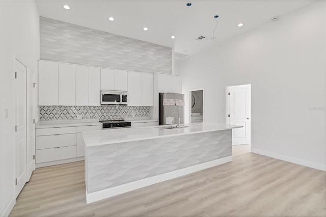 2551 Alhaven Ter, North Port, FL 34286 - kitchen featuring a spacious island, visible vents, a towering ceiling, modern cabinets, and appliances with stainless steel finishes