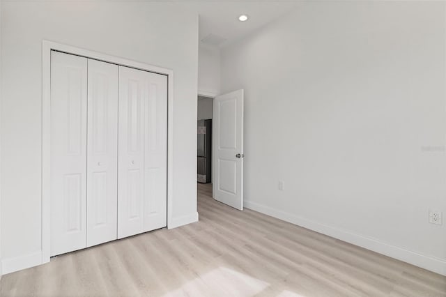 2551 Alhaven Ter, North Port, FL 34286 - unfurnished bedroom with recessed lighting, stainless steel fridge, a closet, light wood finished floors, and baseboards