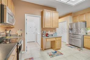 5005 Cape Hatteras Dr, Clermont, FL 34714 - kitchen featuring stainless steel appliances, light tile patterned floors, and light brown cabinetry