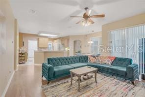 5005 Cape Hatteras Dr, Clermont, FL 34714 - living area with baseboards, a ceiling fan, arched walkways, and wood finished floors