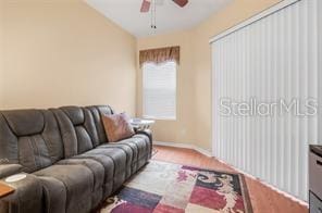 5005 Cape Hatteras Dr, Clermont, FL 34714 - living area featuring ceiling fan, baseboards, and lofted ceiling