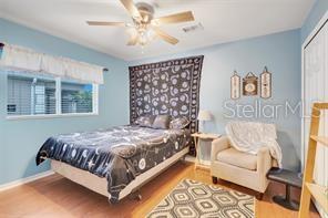 5005 Cape Hatteras Dr, Clermont, FL 34714 - bedroom featuring a closet, baseboards, a ceiling fan, and wood finished floors