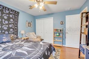 5005 Cape Hatteras Dr, Clermont, FL 34714 - bedroom with ceiling fan, a closet, and wood finished floors