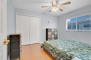 5005 Cape Hatteras Dr, Clermont, FL 34714 - bedroom featuring a closet, wood finished floors, and ceiling fan