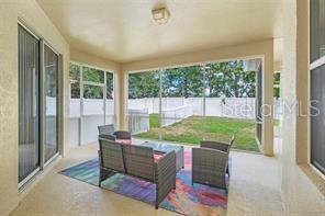 5005 Cape Hatteras Dr, Clermont, FL 34714 - view of patio / terrace with outdoor lounge area and fence