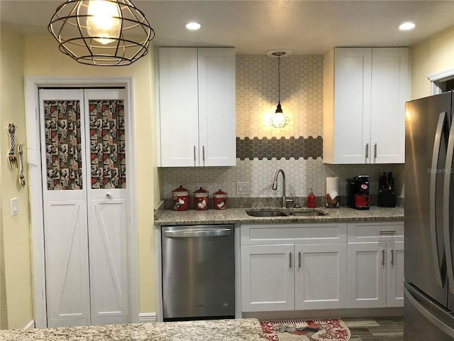 kitchen featuring a sink, appliances with stainless steel finishes, and white cabinetry