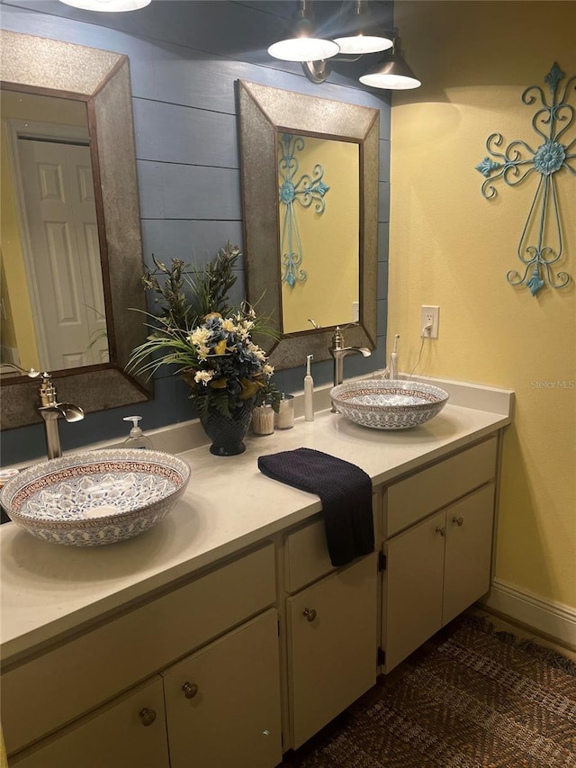 full bathroom featuring double vanity and a sink