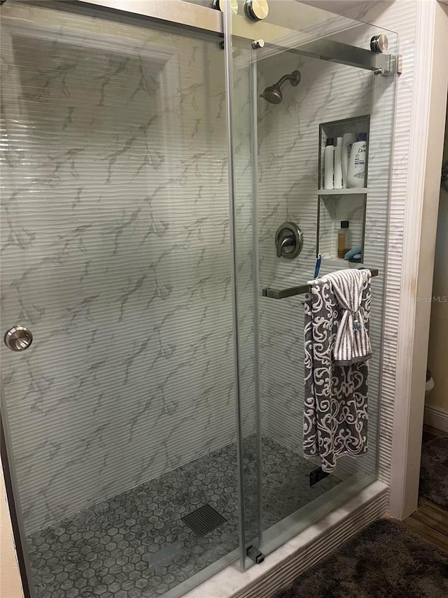 bathroom featuring a shower stall and toilet