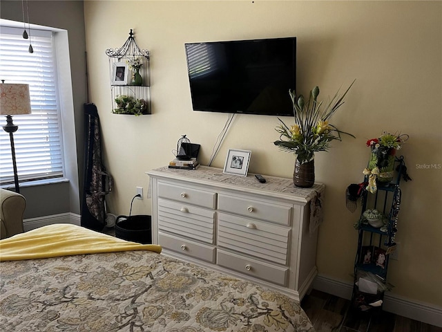 bedroom with wood finished floors and baseboards