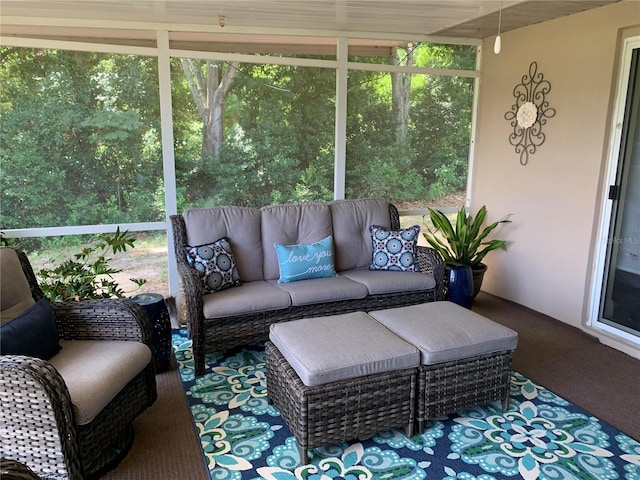 sunroom featuring a wealth of natural light and an outdoor living space
