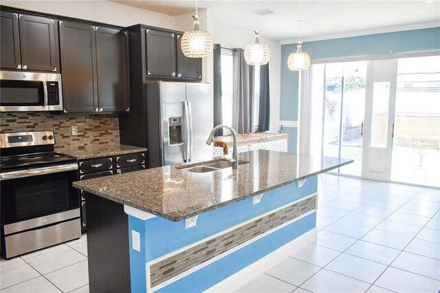 184 Lake Smart Cir, Winter Haven, FL 33881 - kitchen with appliances with stainless steel finishes, a sink, dark stone countertops, decorative backsplash, and light tile patterned flooring