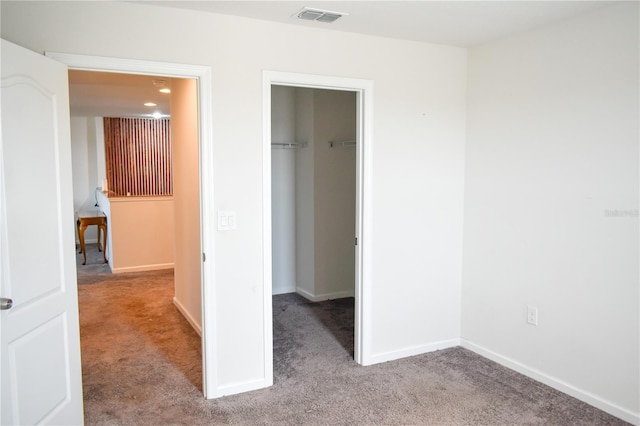 184 Lake Smart Cir, Winter Haven, FL 33881 - unfurnished bedroom with carpet flooring, a spacious closet, baseboards, and a closet