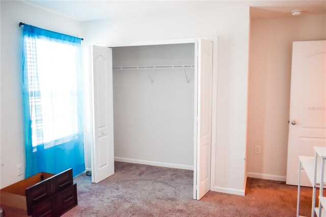 184 Lake Smart Cir, Winter Haven, FL 33881 - unfurnished bedroom with carpet flooring, a closet, and baseboards