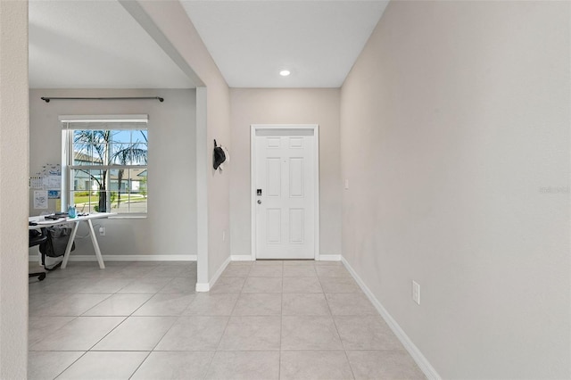 entrance foyer featuring baseboards and light tile patterned floors