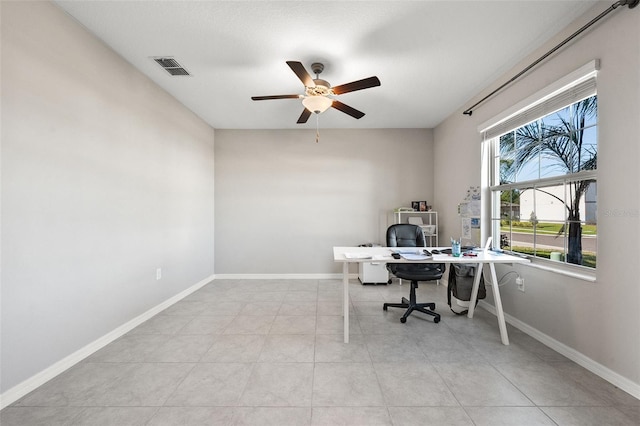 tiled home office with visible vents, baseboards, and ceiling fan