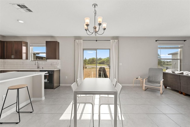 dining room with visible vents, baseboards, recessed lighting, light tile patterned floors, and a notable chandelier