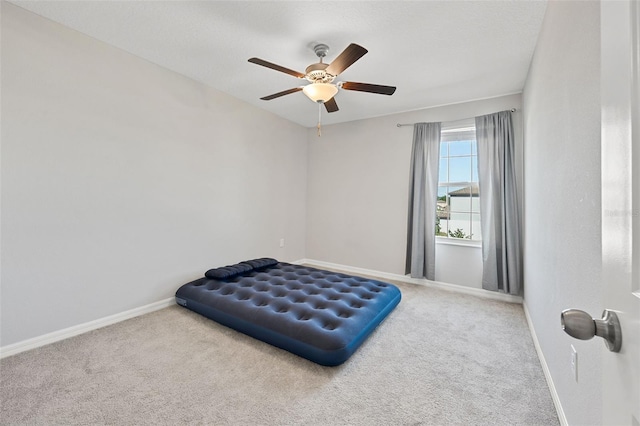 bedroom with carpet floors, a ceiling fan, and baseboards
