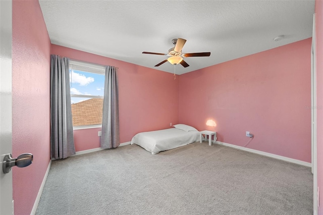 unfurnished bedroom featuring baseboards, carpet, and a ceiling fan