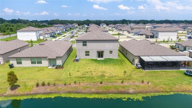 drone / aerial view featuring a water view and a residential view
