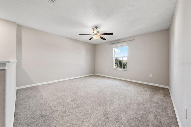 spare room featuring carpet flooring, ceiling fan, and baseboards