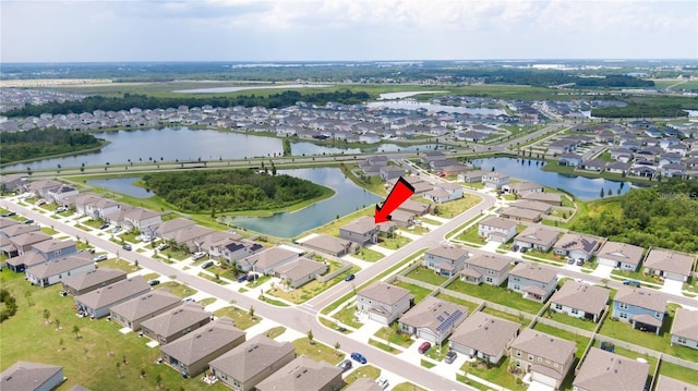 drone / aerial view with a water view and a residential view