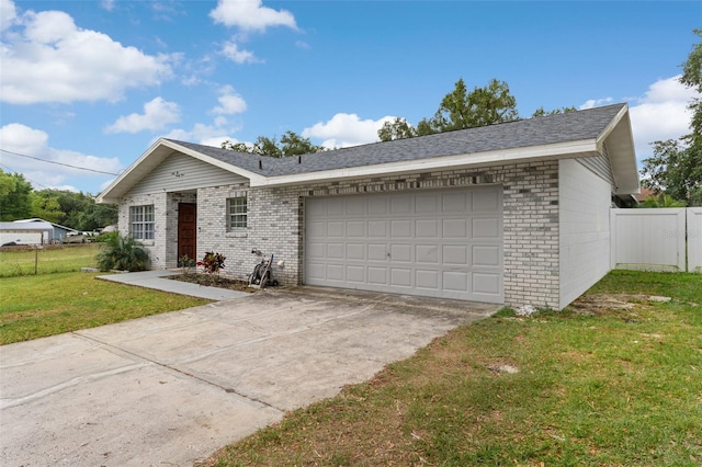 single story home featuring a garage, a front yard, fence, brick siding, and concrete driveway