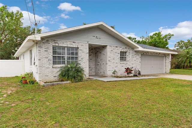 view of front of house with concrete driveway, an attached garage, a front lawn, brick siding, and fence