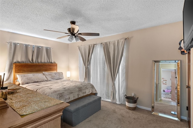 bedroom featuring carpet flooring, a textured ceiling, baseboards, and ceiling fan