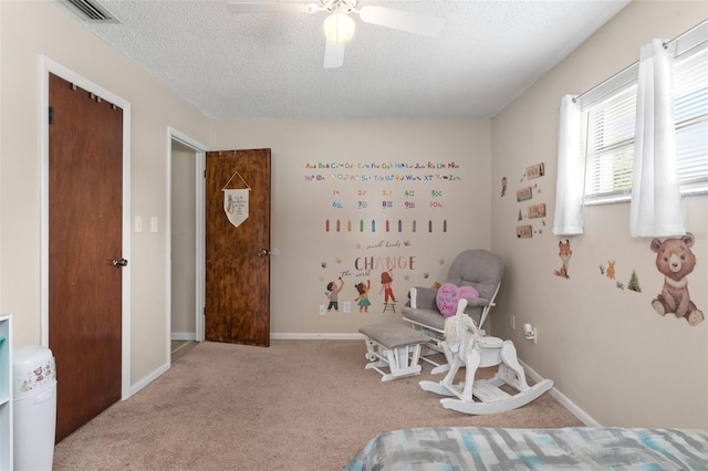 bedroom with a textured ceiling, carpet flooring, a ceiling fan, and visible vents