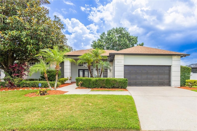 8023 Canyon Lake Cir, Orlando, FL 32835 - view of front facade featuring a front yard, concrete driveway, an attached garage, stucco siding, and a shingled roof