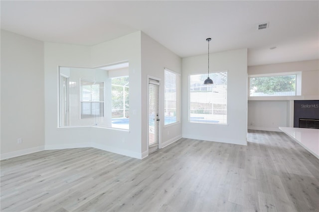 8023 Canyon Lake Cir, Orlando, FL 32835 - unfurnished dining area with light wood-style flooring, a fireplace, and baseboards