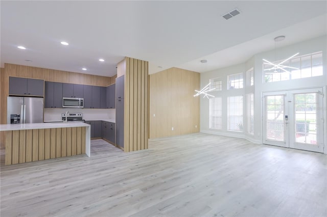 8023 Canyon Lake Cir, Orlando, FL 32835 - kitchen featuring appliances with stainless steel finishes, light countertops, light wood-style flooring, open floor plan, and recessed lighting