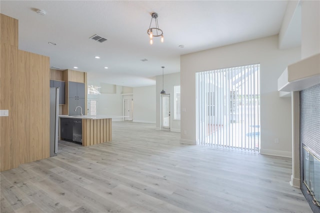 8023 Canyon Lake Cir, Orlando, FL 32835 - unfurnished living room with light wood-style flooring, a sink, baseboards, and recessed lighting