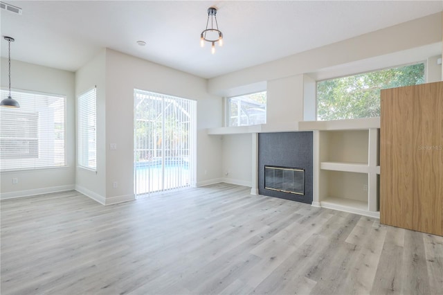 8023 Canyon Lake Cir, Orlando, FL 32835 - unfurnished living room featuring wood finished floors, baseboards, and a tile fireplace