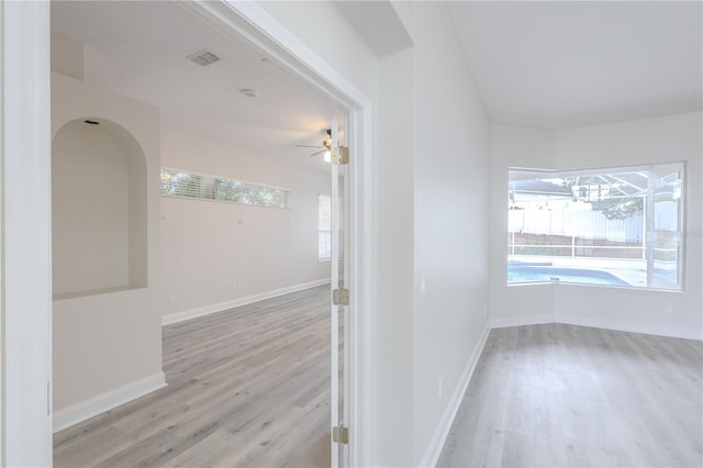 8023 Canyon Lake Cir, Orlando, FL 32835 - hallway with light wood finished floors, plenty of natural light, and baseboards