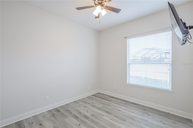 8023 Canyon Lake Cir, Orlando, FL 32835 - empty room with healthy amount of natural light, a ceiling fan, light wood finished floors, and baseboards