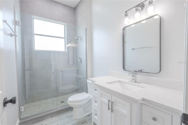 8023 Canyon Lake Cir, Orlando, FL 32835 - bathroom with toilet, a stall shower, wood finished floors, and vanity