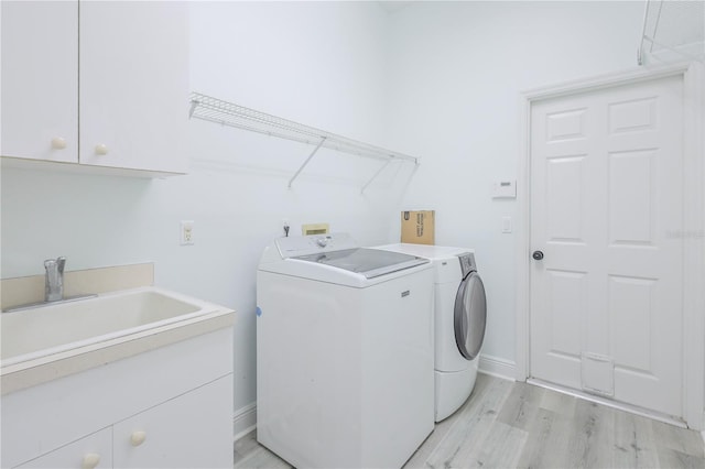 8023 Canyon Lake Cir, Orlando, FL 32835 - washroom with washer and dryer, light wood-style floors, cabinet space, and baseboards