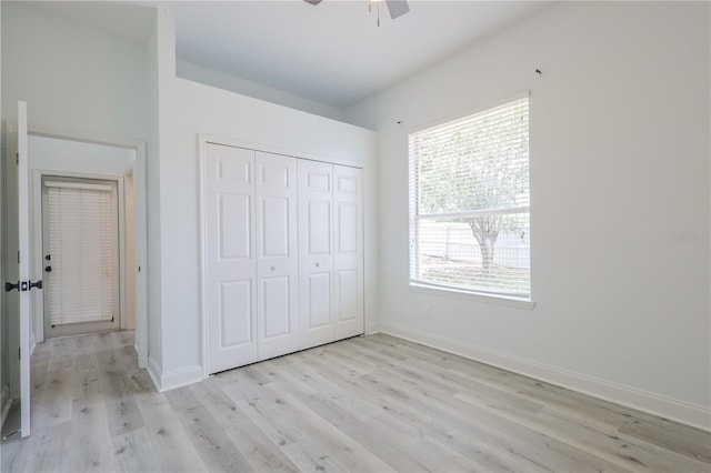8023 Canyon Lake Cir, Orlando, FL 32835 - unfurnished bedroom featuring light wood-style flooring, baseboards, a closet, and a ceiling fan